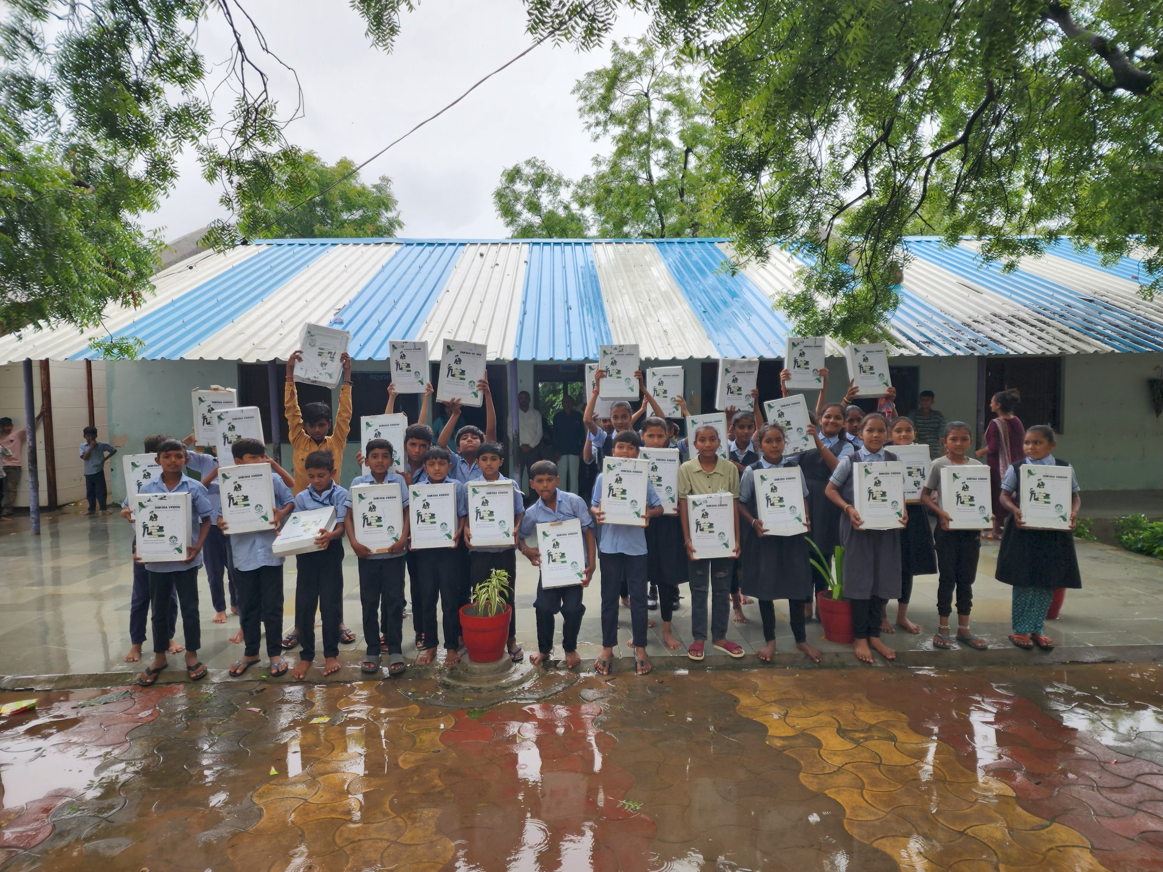 Students holding up educational kits